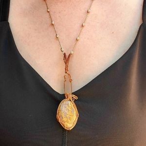 Polished dinosaur 🦕 bone pendant with chain.